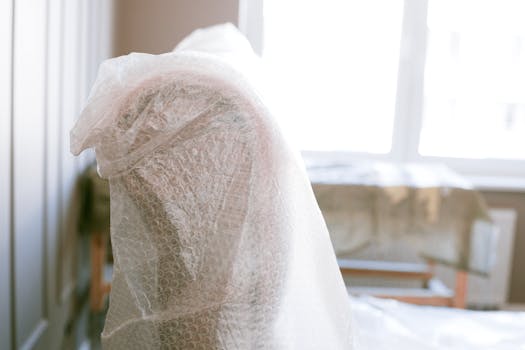 pexels photo 3616736 3616736 Furniture wrapped in bubble wrap for protection during a move in a bright sunlit room.