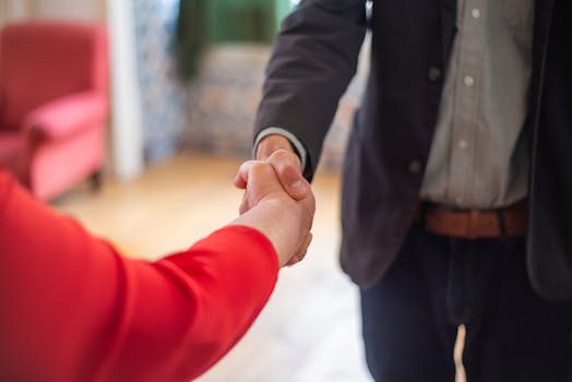 pexels photo 8439706 8439706 Close-up view of two people shaking hands indoors, symbolizing agreement or partnership.